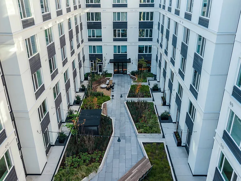 Experience the serenity of Modera Morrison's outdoor courtyard with lush landscaping, right in the heart of Portland.