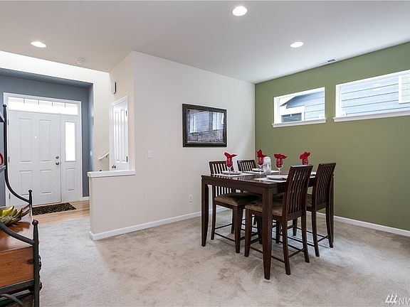 Entry Hall with coat closet and stairway to the upstairs, takes you into the light filled dining area.