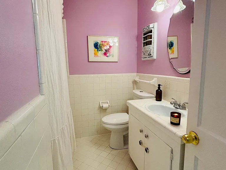 Private bathroom with updated fixtures and plenty of light.