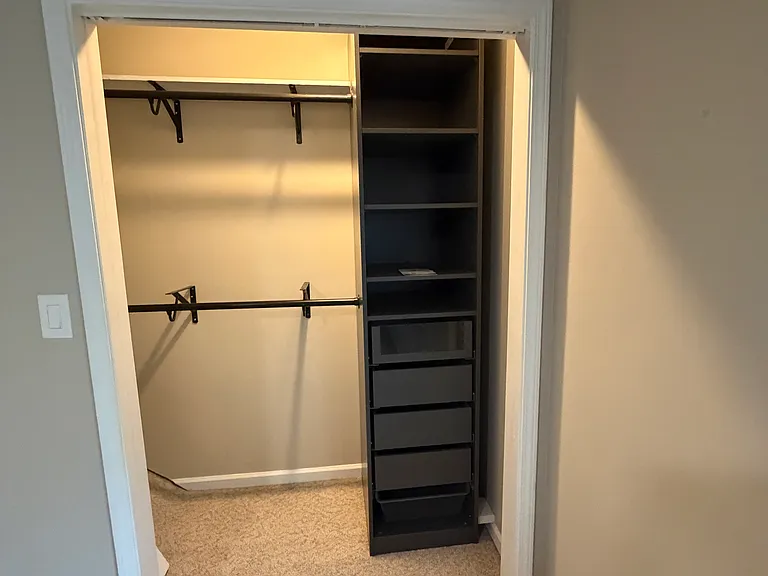 Front bedroom with a full bathroom and closet with built-ins.