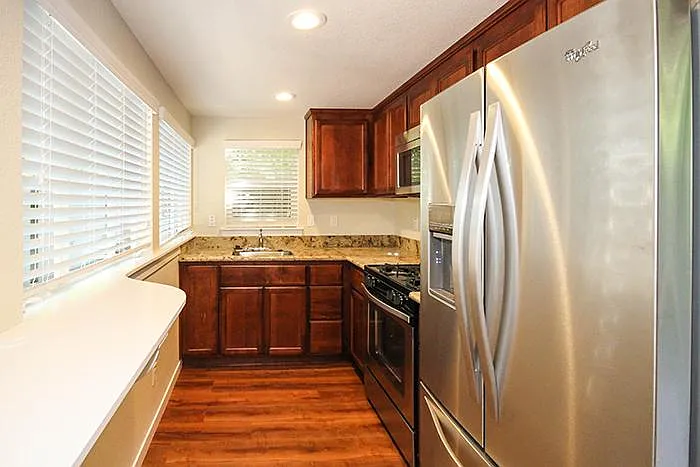 Kitchen with granite counter tops and stainless steel appliances.