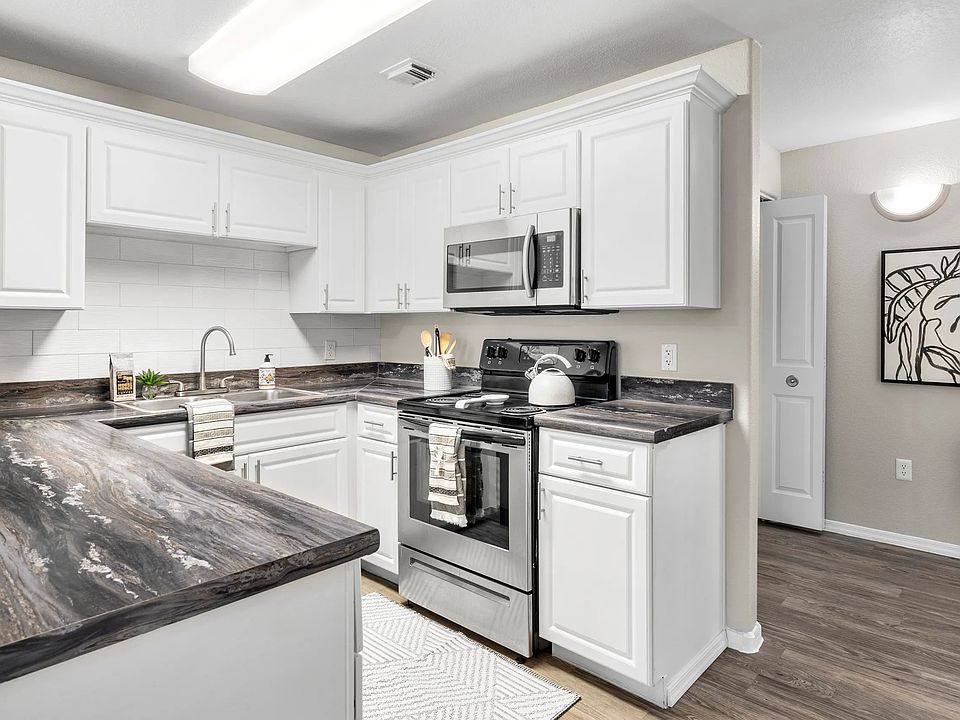 Whip up culinary masterpieces in a gleaming kitchen with abundant storage and modern appliances.