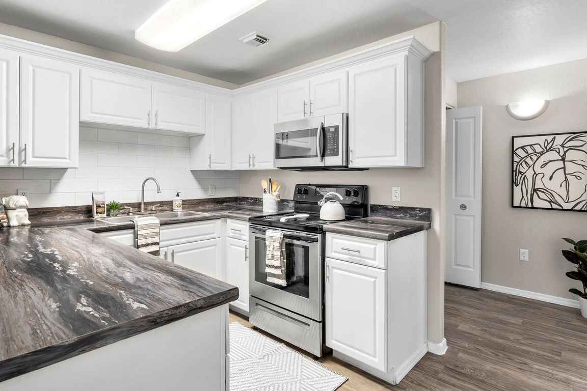 Whip up culinary masterpieces in a gleaming kitchen with abundant storage and modern appliances.