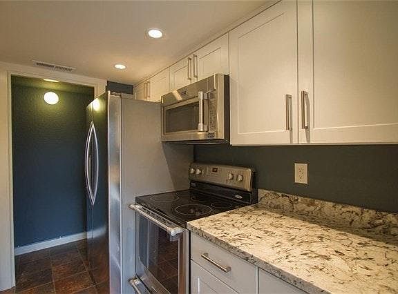 Kitchen w/slab granite counters