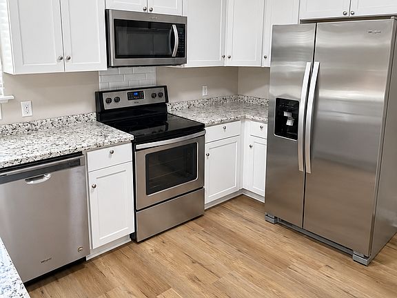Kitchen with stainless steel appliances, bright cabinetry, and plenty of counter space.