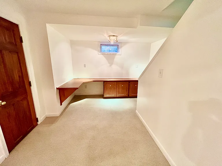Built in desk area that is at the bottom of the stairs when you walk into the basement. Great lighting in the hallway and LED lights over the desk.