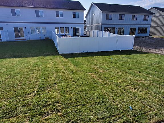 Back yard goes to white fence