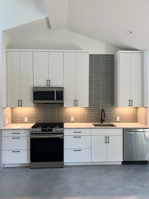 Open living space with vaulted ceiling. Ample storage.