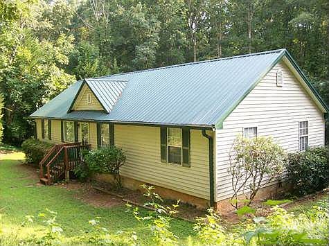 Front View Shows Updated Siding And Metal Roof