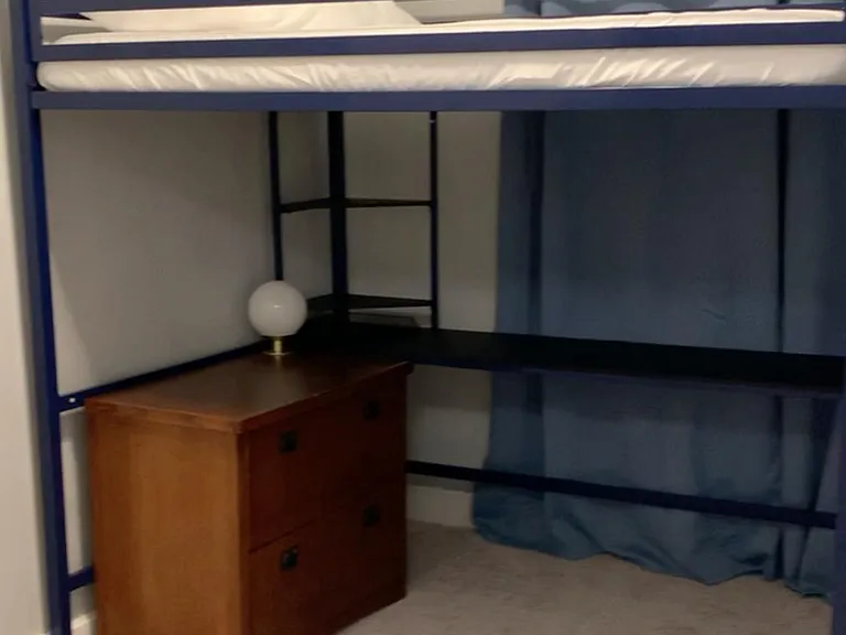 This is the Blue Crab Room with a closet, loft bed and built in desk below the full size loft bed.