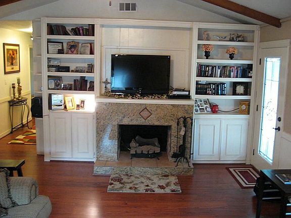 This gas log fireplace is the center of attention in your Large Open Living room w/built in bookshelves!
