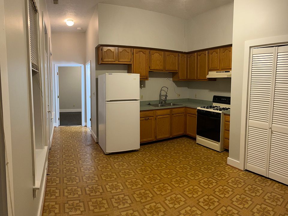 Kitchen/ living room combo. Bedroom is located at end of hall. Balcony door is situated across from fridge.
