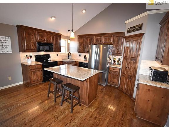 Awesome Kitchen with Gorgeous Granite, Tons of Rich Dark Cabinets, Beautiful Hardwood Floors, and spacious Walkin Pantry.