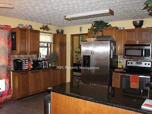 Kitchen with Granite Countertops and Stone Backsplash