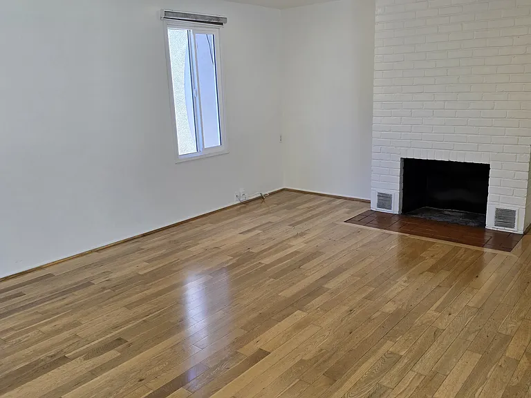 View of family size living room with smooth ceiling lots of light bright sunshine