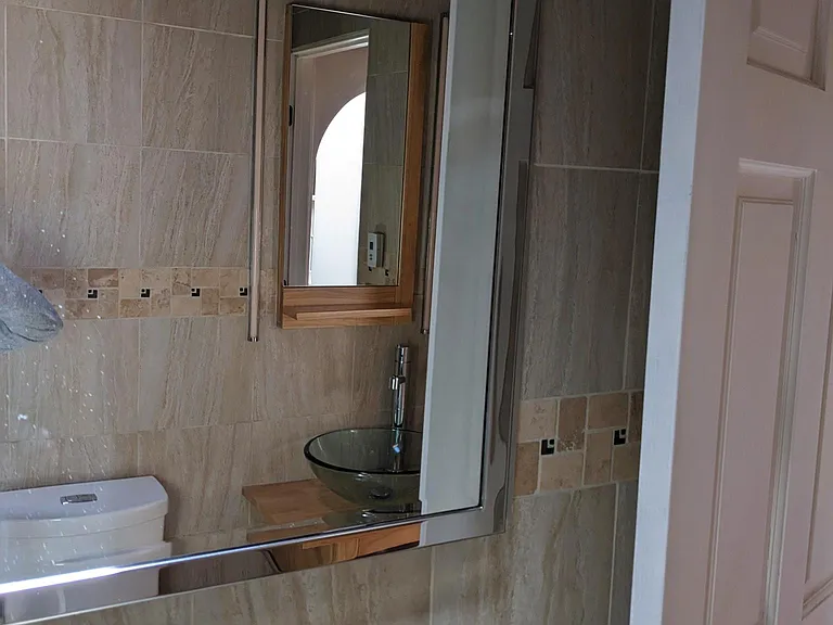 In-wall storage behind the sliding mirror