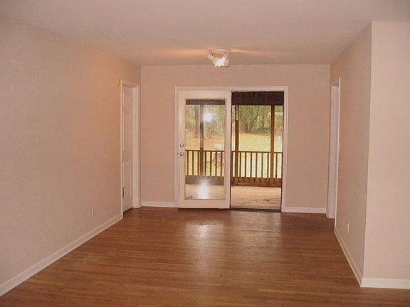 Dining area opens to screened porch through French doors.
