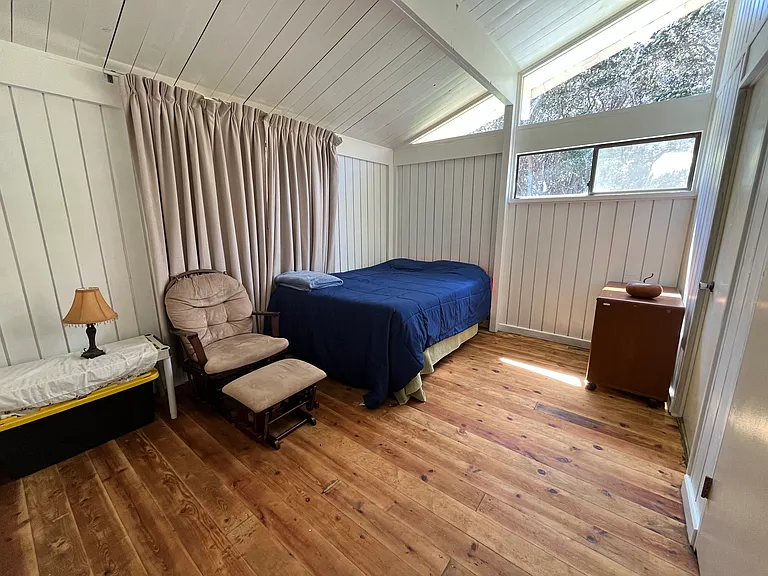 Primary bedroom with queen bed and en suite half bath.