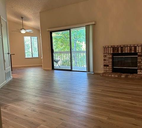 Open floorplan with vaulted ceilings and fireplace