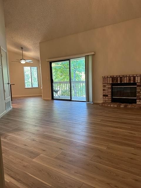 Open floorplan with vaulted ceilings and fireplace