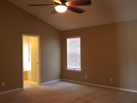 Large master bedroom with vaulted ceiling.