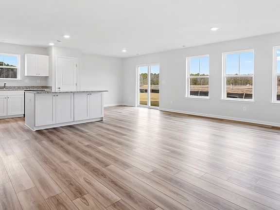 Open kitchen and family room in a DRB Homes Edgewood plan at The Village of College Park community.