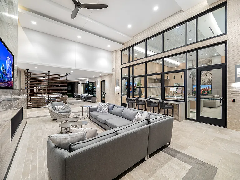 Luxurious open-concept living space featuring plush seating, sleek modern design, and ample natural light for ultimate relaxation and entertainment.