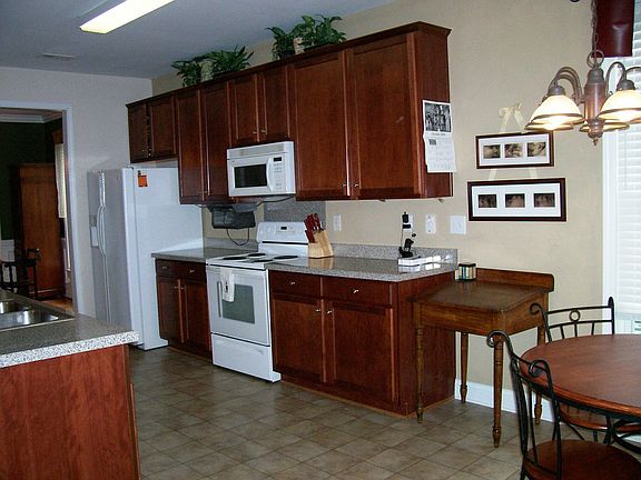 Plenty of cabinets in this open eat-in kitchen