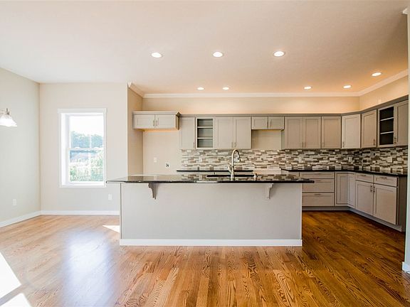 Open-concept kitchen, dining and living room.