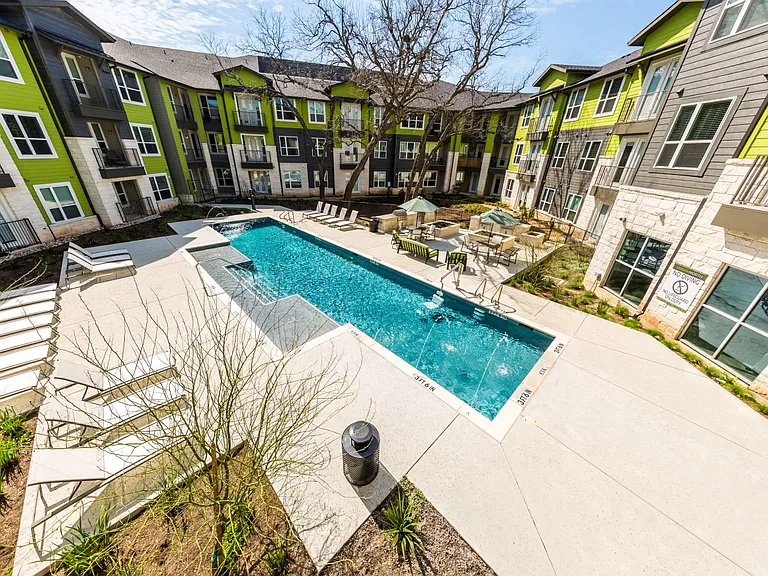 Pool overview with poolside seating, and BBQ area