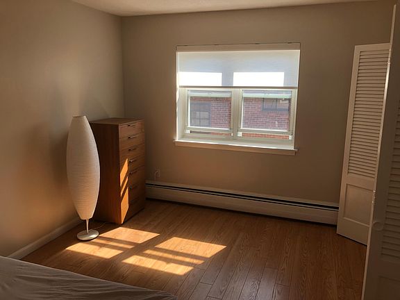 Bedroom with furnished light and dresser.