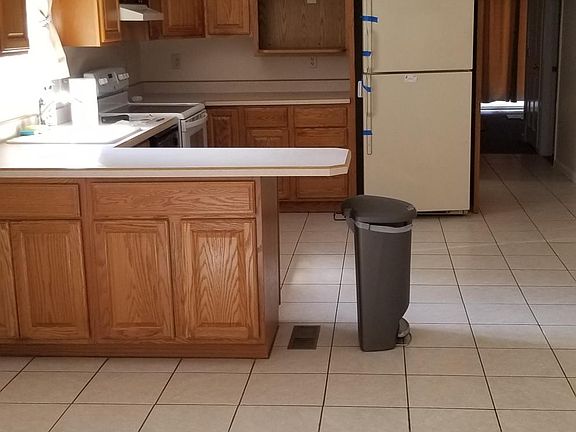 Kitchen with oak cabinets and tile flooring