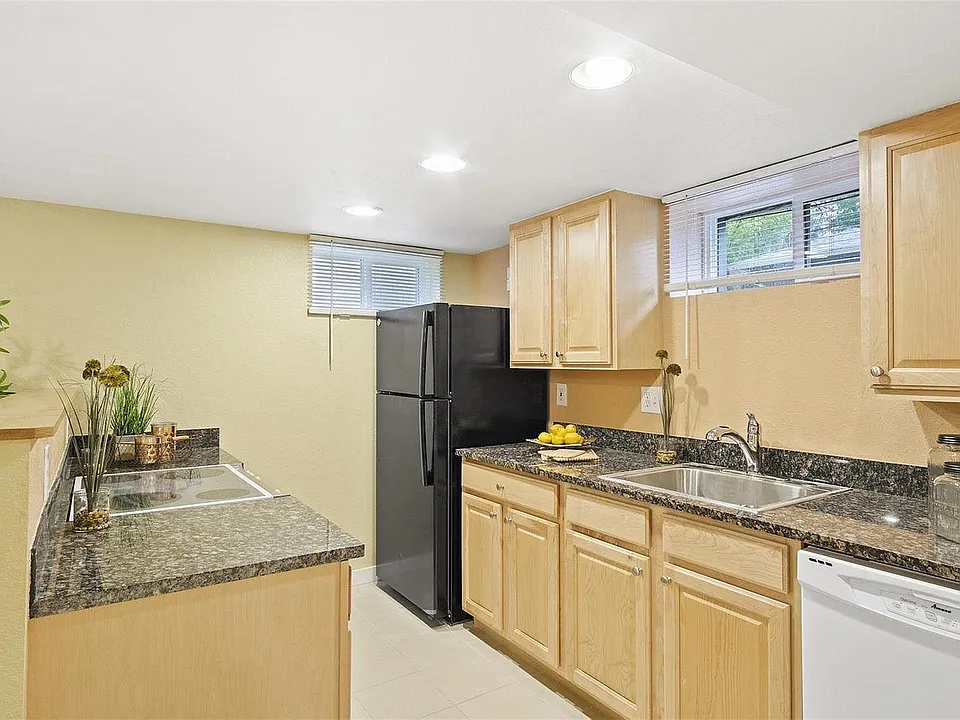 Updated kitchen with granite countertops, dishwasher, fridge, and stove.
