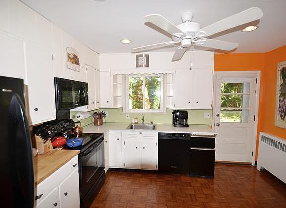 Kitchen: updated stove & lighting + door to yard
