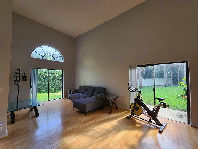 Vaulted living room with signature half-moon window