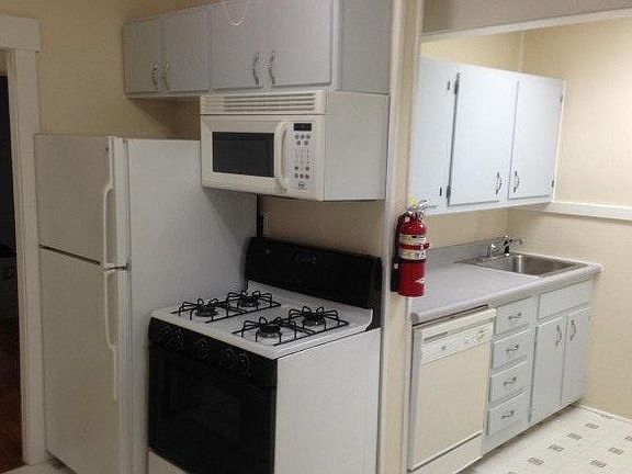 Kitchen view Refrigerator, Stove, Microwave, and Dishwasher