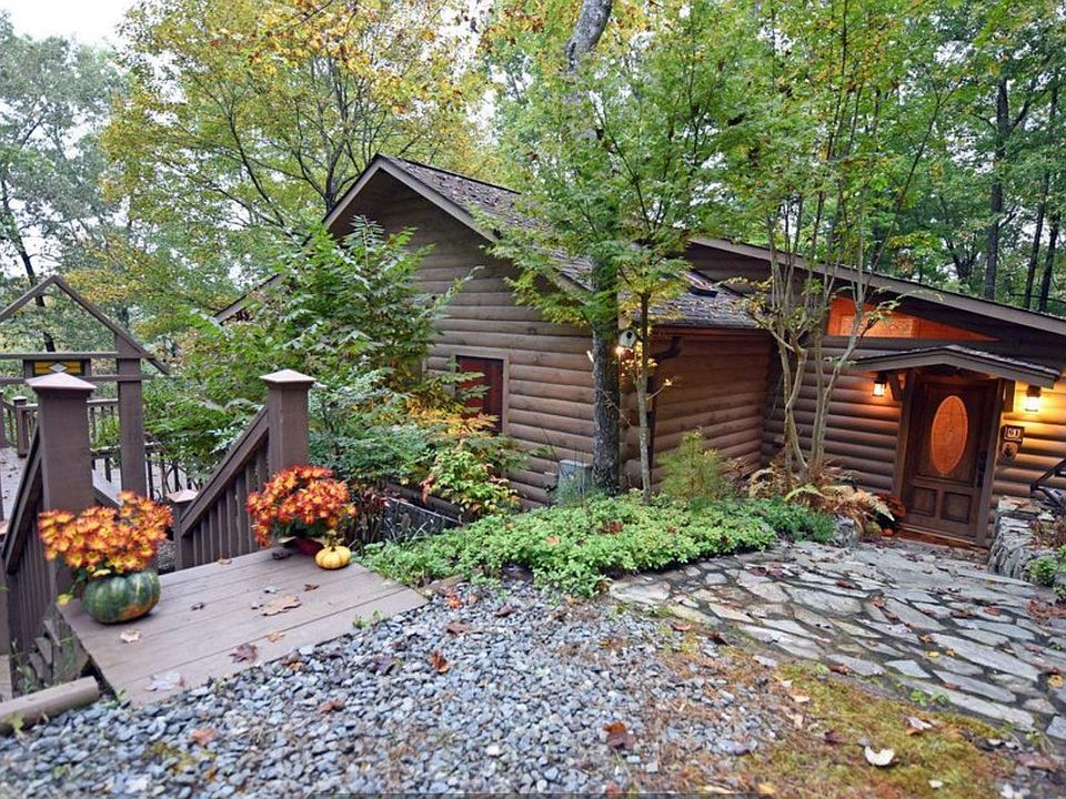 Entrance to house from upper level parking area- steps to front door and deck