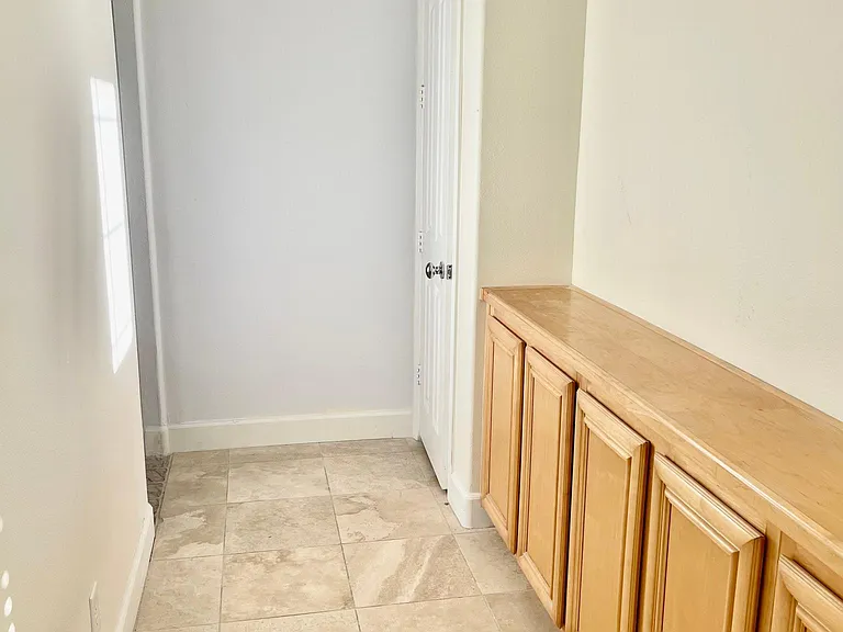 Cabinet Storage in hallway with closet