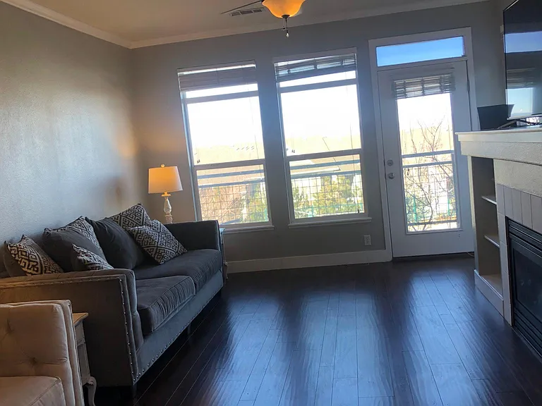 Very spacious unit with large private balcony accessed through living room (door to balcony and balcony "walls" pictured through the windows). A ceiling fan keeps air moving when the windows are closed