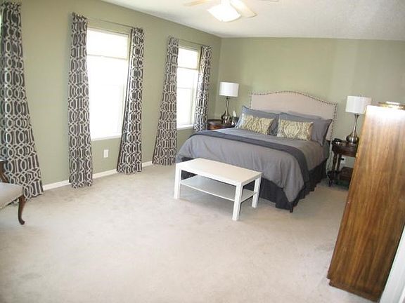 Large master suite features a private bath and walk in closet.