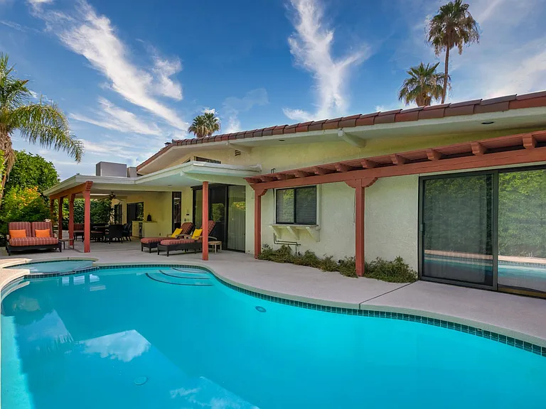 Pool and spa with view to shade structure.