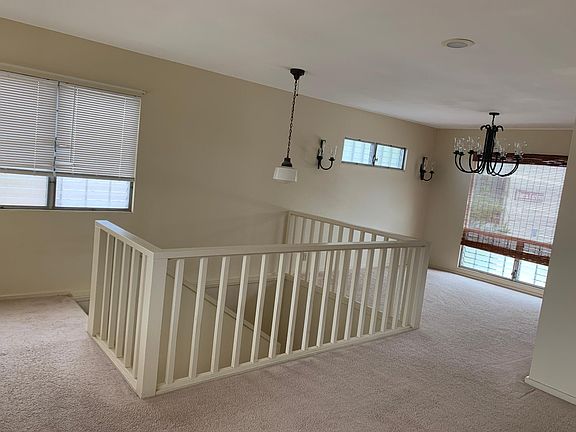 View from living room showing top of stairs and dining area