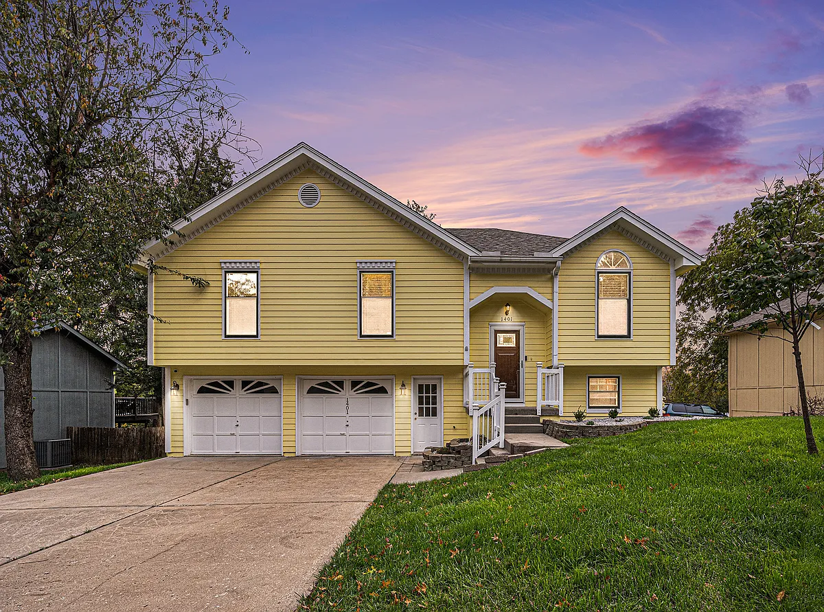 In the evening, the front exudes a cozy and charming atmosphere, softly lit to make the home feel welcoming and enchanting. - 1401 NE Weddle Ln