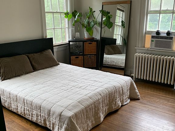 Large sunny hardwood floor bedroom!