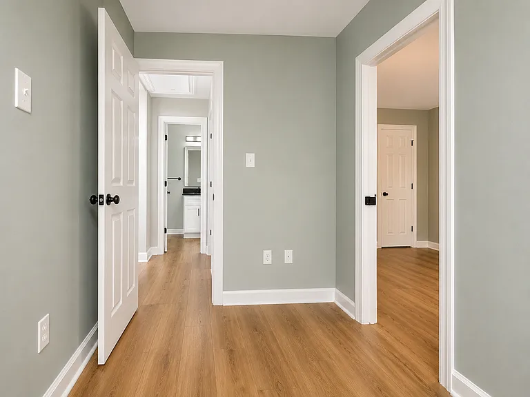 Upstairs secondary bedroom looking out towards landing & master bath.
