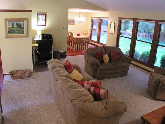 Main Level.  Another view of the living room with the dining room beyond.  Another wall of windows allow even more natural light to make you feel like you are outdoors.