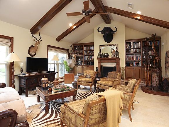 Spacious family room with stone floors, gas log fireplace with antique Pennsylvania mantle (circa 1860, per seller)