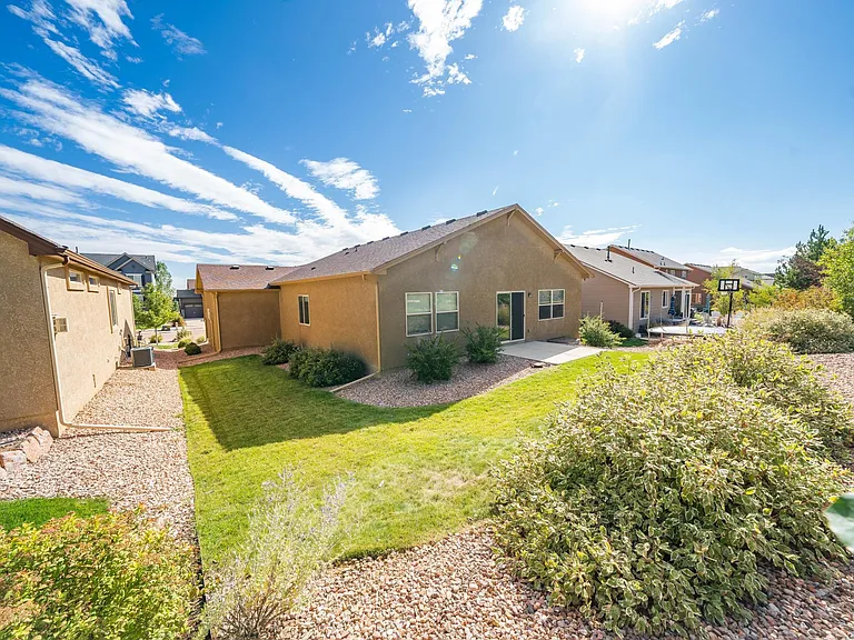 backyard - no fence, which explains why no dogs - patio with sliding glass door from kitchen/great-room - windows to left of sliding door are from master BR