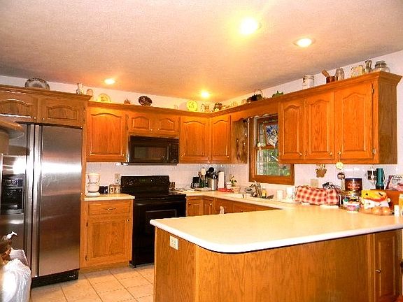 Solid surface counter tops. nice cabinets and tiled backsplash
