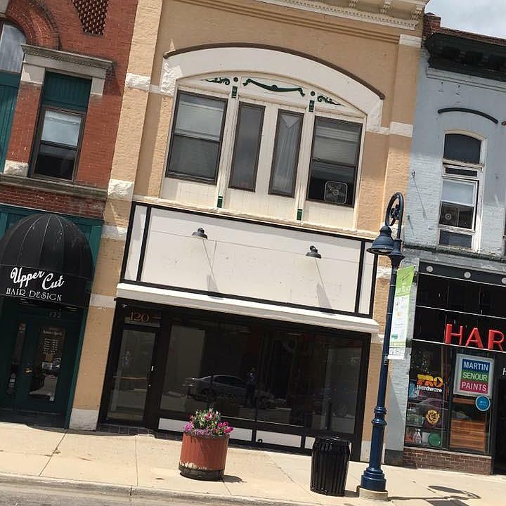The windows in this apartment face Main Street. 